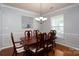 Formal dining room boasts elegant trim, a classic chandelier, and wood flooring at 4003 Fine Robe Dr, Indian Trail, NC 28079