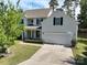 Attractive two-story home with a spacious driveway, lush lawn, and a welcoming front porch at 4003 Fine Robe Dr, Indian Trail, NC 28079