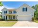 Charming two-story home with a well-manicured lawn, inviting front porch and a two-car garage at 4003 Fine Robe Dr, Indian Trail, NC 28079