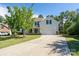 Charming two-story home with a well-manicured front yard and a spacious driveway, set against a blue sky at 4003 Fine Robe Dr, Indian Trail, NC 28079