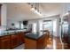 Open kitchen features granite countertops, stainless steel appliances, eat-in area, and living room fireplace at 4003 Fine Robe Dr, Indian Trail, NC 28079