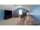 Cozy living room with a large TV, plush sofa, and comfortable recliners, ideal for relaxation at 4003 Fine Robe Dr, Indian Trail, NC 28079