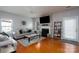 Cozy living room boasts hardwood floors, a decorative fireplace, and a comfortable seating arrangement at 4003 Fine Robe Dr, Indian Trail, NC 28079