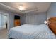 Bright main bedroom featuring a tray ceiling, fan, and a television on a bureau at 4003 Fine Robe Dr, Indian Trail, NC 28079