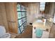 Retro bathroom with patterned wallpaper, shower with floral curtain, and vintage fixtures at 402 Villa St, Kannapolis, NC 28083