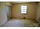 Neutral bedroom with mirror sliding closet doors and a bright window at 402 Villa St, Kannapolis, NC 28083