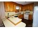 Retro kitchen with wood cabinets and vintage appliances, awaiting a modern remodel to maximize its potential at 402 Villa St, Kannapolis, NC 28083