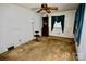 Spacious living room with potential for redesign, featuring a ceiling fan and natural light to personalize at 402 Villa St, Kannapolis, NC 28083
