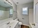 A well-lit bathroom with a single vanity, framed mirror, and tiled shower at 4328 Frank Vance Rd, Charlotte, NC 28216