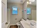 Cozy bathroom featuring laminate floors, a single sink vanity, and a bathtub with shower at 4328 Frank Vance Rd, Charlotte, NC 28216