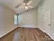 Spacious bedroom featuring laminate flooring, ceiling fan, a vaulted ceiling, and two windows for ample natural light at 4328 Frank Vance Rd, Charlotte, NC 28216