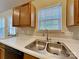 Bright kitchen with stainless steel sink, laminate countertop, and wooden cabinets offering ample storage at 4328 Frank Vance Rd, Charlotte, NC 28216