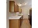 Kitchen with wood cabinets, white countertops, laminate floors, and stainless steel sink at 4328 Frank Vance Rd, Charlotte, NC 28216