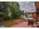Outdoor back deck features a red railing and a stainless steel grill, with a view of the backyard and wooded area at 4920 Surfwood Dr, Sherrills Ford, NC 28673