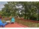 Outdoor back deck features a red railing and some blue furniture with a view of the backyard and wooded area at 4920 Surfwood Dr, Sherrills Ford, NC 28673