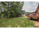 The backyard features a red back deck, a big green grass yard, and a white garage in a wooded area at 4920 Surfwood Dr, Sherrills Ford, NC 28673