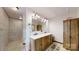 Bathroom featuring a double sink vanity, large mirror, and walk-in tiled shower at 4920 Surfwood Dr, Sherrills Ford, NC 28673