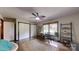 Bright bedroom with a ceiling fan, hardwood floors, an area rug and a work area by the window at 4920 Surfwood Dr, Sherrills Ford, NC 28673
