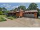 Wood home with a side-entry two-car garage and beautiful landscaping at 4920 Surfwood Dr, Sherrills Ford, NC 28673