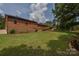 The backyard features a back deck with a set of stairs, a big green grass yard, and a wooded area at 4920 Surfwood Dr, Sherrills Ford, NC 28673