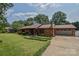 Well-maintained home with a spacious front yard, wood siding, and attached garage at 4920 Surfwood Dr, Sherrills Ford, NC 28673