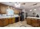 Kitchen with wooden cabinets, black appliances, breakfast bar and tile flooring at 4920 Surfwood Dr, Sherrills Ford, NC 28673
