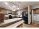 Kitchen with wooden cabinets, black appliances, breakfast bar and doorway to laundry room at 4920 Surfwood Dr, Sherrills Ford, NC 28673