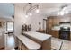 Well-lit kitchen features a breakfast bar, wooden cabinetry, and a mix of tile and wood flooring at 4920 Surfwood Dr, Sherrills Ford, NC 28673