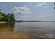 Picturesque lake view highlighting clear waters, a private dock, and distant shoreline under a blue sky at 4920 Surfwood Dr, Sherrills Ford, NC 28673