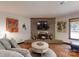 Charming living room with a brick fireplace, hardwood floors, and cozy atmosphere at 4920 Surfwood Dr, Sherrills Ford, NC 28673