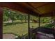 Covered porch with a swing, plants and views of the spacious front yard at 4920 Surfwood Dr, Sherrills Ford, NC 28673