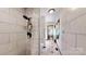 Shower with white subway tile and stone-look floor in bathroom at 4920 Surfwood Dr, Sherrills Ford, NC 28673