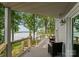 Covered wooden back porch with a seating area overlooks the lake at 5075 Lakeview Cir, Sherrills Ford, NC 28673