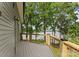 View of a light gray wooden back porch with wood railing overlooking a gorgeous lake at 5075 Lakeview Cir, Sherrills Ford, NC 28673