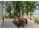 Wooden table and bench seat on a spacious back porch with lake views at 5075 Lakeview Cir, Sherrills Ford, NC 28673