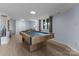 Spacious basement featuring a pool table, wood flooring, and a window bringing in natural light at 5075 Lakeview Cir, Sherrills Ford, NC 28673