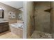 Primary bath with soaking tub, granite counters, and tile shower at 5075 Lakeview Cir, Sherrills Ford, NC 28673