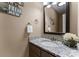 Cozy powder room features granite countertops and decorative vanity mirror at 5075 Lakeview Cir, Sherrills Ford, NC 28673