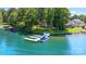 Stunning lakefront property with a private dock and boat, surrounded by lush greenery at 5075 Lakeview Cir, Sherrills Ford, NC 28673