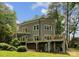 Gray two-story home with large decks overlooking the backyard and brick foundation at 5075 Lakeview Cir, Sherrills Ford, NC 28673