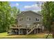 Back exterior of home with multiple decks, patio seating, and stairs to the yard at 5075 Lakeview Cir, Sherrills Ford, NC 28673