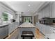 Bright kitchen featuring white cabinets, a granite island with seating, and stainless steel appliances at 5075 Lakeview Cir, Sherrills Ford, NC 28673