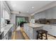 Bright kitchen featuring white cabinets, a granite island with seating, and stainless steel appliances at 5075 Lakeview Cir, Sherrills Ford, NC 28673