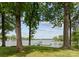 Scenic waterfront view of the lake with a private dock, seen through mature trees at 5075 Lakeview Cir, Sherrills Ford, NC 28673