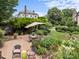 Beautifully landscaped backyard with a brick patio, complemented by an umbrella-covered table and well-manicured garden beds at 603 S Fulton St, Salisbury, NC 28144