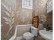 Charming powder room with unique wallpaper, mosaic tile floor, and vintage-inspired decor at 603 S Fulton St, Salisbury, NC 28144