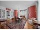 Elegant dining room with patterned wallpaper, a chandelier, and large windows with custom drapes at 603 S Fulton St, Salisbury, NC 28144