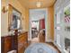 Charming foyer showcasing hardwood floors, a vintage dresser, and a view to the dining room at 603 S Fulton St, Salisbury, NC 28144