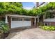 Two car garage with decorative door and lush wisteria adding curb appeal at 603 S Fulton St, Salisbury, NC 28144