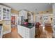 Open kitchen featuring white cabinetry, a central island with seating, and stainless steel appliances at 603 S Fulton St, Salisbury, NC 28144
